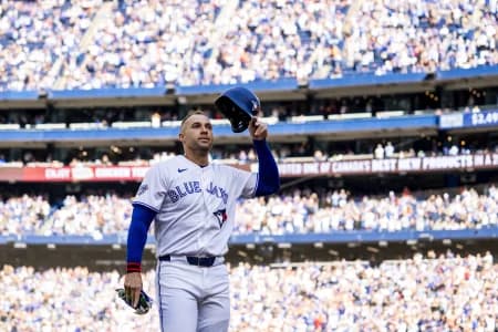 Toronto Blue Jays designated hitter George Springer (4) waves to the fans after being replaced in the during the third inning against the Cincinnati Reds at Rogers Centre.