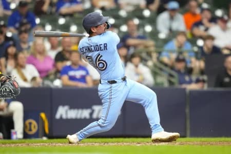 Toronto Blue Jays pinch hitter Davis Schneider (36) hits a double during the ninth inning against the Milwaukee Brewers at American Family Field