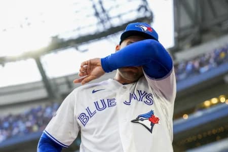 Toronto Blue Jays designated hitter George Springer (4) wipes tears away after playing his final MLB game against the Cincinnati Reds at Rogers Centre.