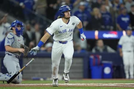 Toronto Blue Jays third baseman Addison Barger (47) runs after hitting a single against the Los Angeles Dodgers in the second inning during game seven of the 2025 MLB World Series at Rogers Centre.