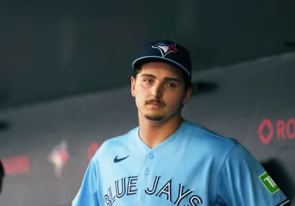 Toronto Blue Jays relief pitcher Ricky Tiedemann (33) stands in the dugout against the New York Yankees during the third inning at Rogers Centre