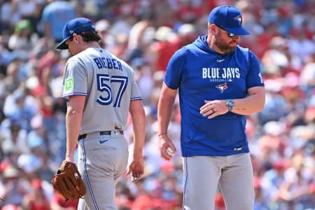 Toronto Blue Jays manager John Schneider (14) take the ball from pitcher Shane Bieber (57) against the Philadelphia Phillies during the sixth inning at Citizens Bank Park
