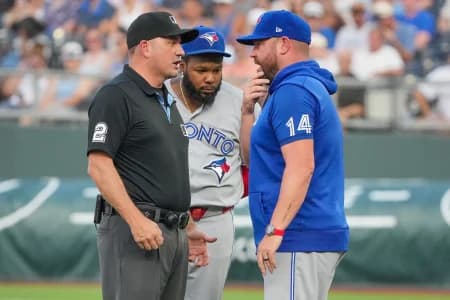 Toronto Blue Jays manager John Schneider (14) talks with umpire Dan Bellino (2) after a balk is called on starting pitcher Max Scherzer (31) (not pictured) against the Kansas City Royals during the first inning at Kauffman Stadium.
