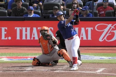 Toronto Blue Jays third baseman Kazuma Okamoto (7) hits a solo home run against the Baltimore Orioles during the fifth inning at Rogers Centre.