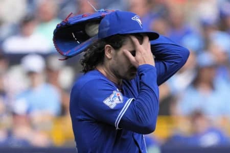 Toronto Blue Jays starting pitcher Dylan Cease (84) wipes his forehead after walking several Baltimore Orioles batters during the first inning at Rogers Centre