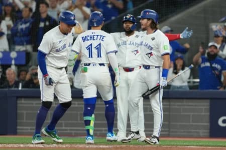 Toronto Blue Jays shortstop Bo Bichette (11) reacts after hitting a three run home run against the Los Angeles Dodgers in the third inning for game seven of the 2025 MLB World Series at Rogers Centre
