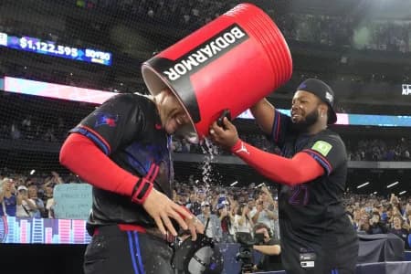 Toronto Blue Jays first baseman Vladimir Guerrero Jr. (27) puts an empty bucket of ice water over top of designated hitter George Springer (4) after a win over the Seattle Mariners at Rogers Centre