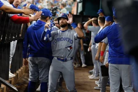Toronto Blue Jays right fielder Nathan Lukes (38) is congratulated by teammates in the dugout after scoring a run during the seventh inning against the Texas Rangers at Globe Life Field.
