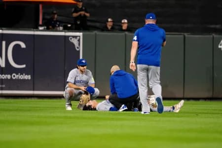 Toronto Blue Jays outfielder Brett Bateman (21) is tended to by training staff after suffering an apparent injury during the second inning at Oriole Park at Camden Yards