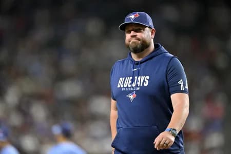 Toronto Blue Jays manager John Schneider walks back to the dugout during the sixth inning against the Texas Rangers at Globe Life Field