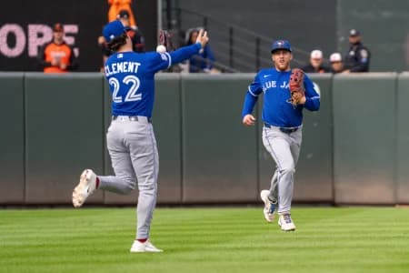 Toronto Blue Jays outfielder Myles Straw (3) looks on as Toronto Blue Jays infielder Ernie Clement (22) attempts to catch a pop fly at Oriole Park at Camden Yards.