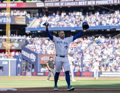 Toronto Blue Jays designated hitter George Springer (4) waves to the fans after being replaced in the during the third inning against the Cincinnati Reds at Rogers Centre.