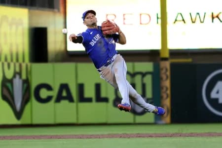 Toronto Blue Jays short stop Andres Gimenez (0) throws a late ball to first base against Athletics first baseman Jeff McNeil (not pictured) during the ninth inning at Sutter Health Park.