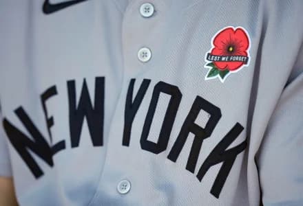 A detailed view of the a red poppy flower patch on the jersey worn by New York Yankees left fielder Cody Bellinger (35) in honor of Memorial Day prior to a game against the Kansas City Royals at Kauffman Stadium.