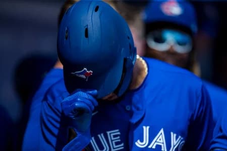 Toronto Blue Jays left fielder Lourdes Gurriel Jr. (13) removes his helmet in the dugout after scoring during a game between the Toronto Blue Jays and the Baltimore Orioles at TD Ballpark.