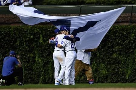 Chicago Cubs left fielder Ian Happ (8), center fielder Pete Crow-Armstrong (4) and right fielder Seiya Suzuki (27) hug after the game against the Miami Marlins at Wrigley Field