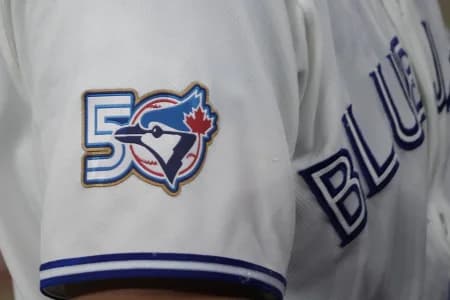 The Toronto Blue Jays 50th anniversary logo displayed on the jersey of third baseman Kazuma Okamoto (7) duringa game against the Athletics at Rogers Centre