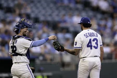 Kansas City Royals catcher Carter Jensen (22) hands the ball to Kansas City Royals pitcher Connor Seabold (43) during the fifth inning against the Tampa Bay Rays at Kauffman Stadium.