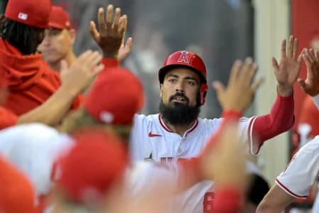 Los Angeles Angels third baseman Anthony Rendon (6)is congratulated in the dugout after scoring on a home run by center fielder Mickey Moniak (16) in the first inning against the Los Angeles Dodgers at Angel Stadium.