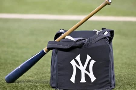 A view of a baseball bat and a New York Yankees bag and logo before the game between the Texas Rangers and the Yankees at Globe Life Field.
